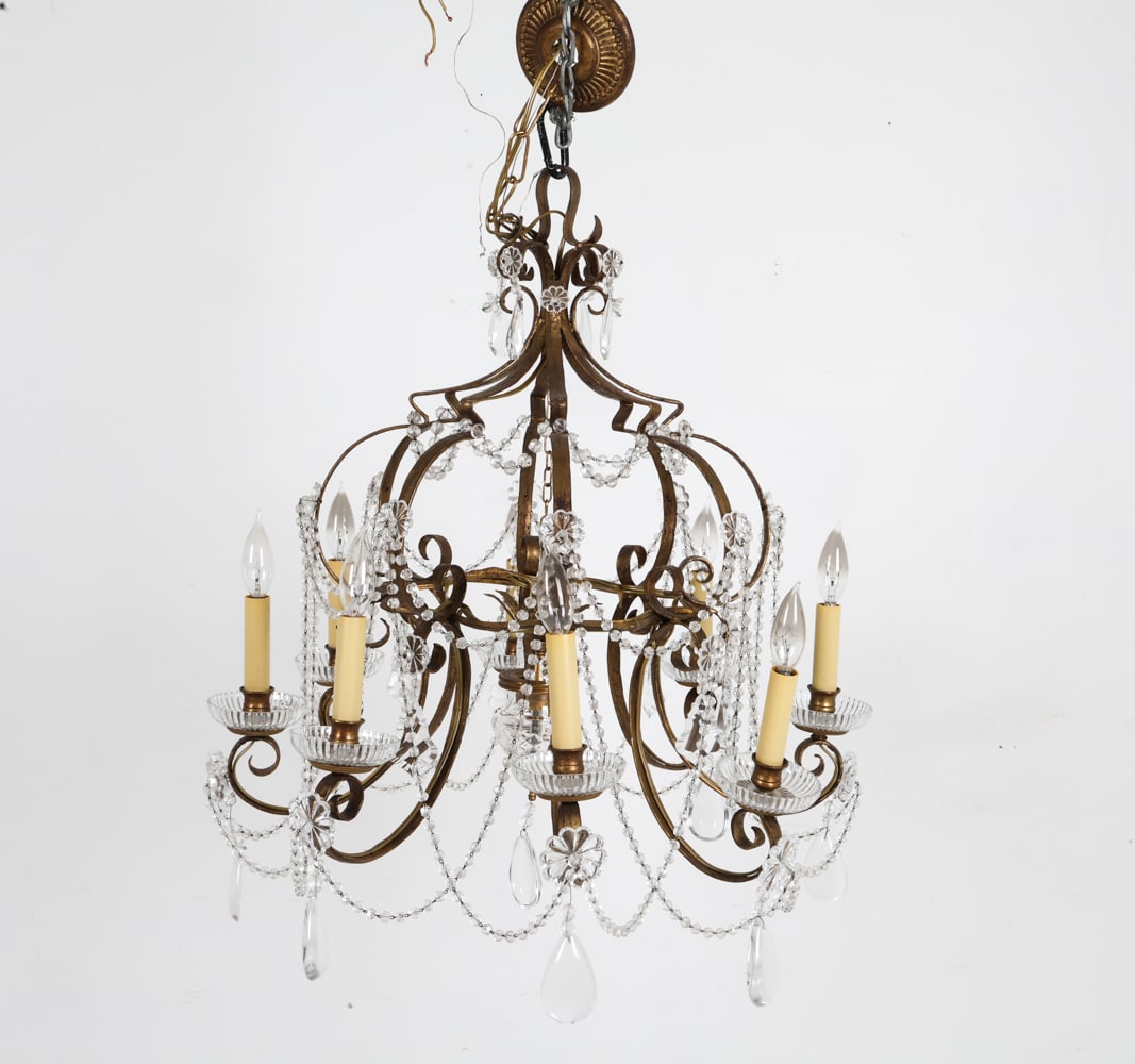 GILT IRON DROP CRYSTAL CHANDELIER: Brass chandelier with crystal drops and beads. Dimensions: H 36" x Dia. 25.25". Condition: Wiring untested. Some scuffs and discoloration to finish. Wear consistent with age and use.