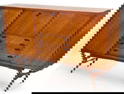 KURT OSTERVIG DANISH TEAK SIDEBOARD C. 1960S: Danish teak sideboard with multiple drawers and sliding doors. Dry bar in center cabinet with frosted decorated mirror and light. Adjustable shelves. Dimensions: H 50" x W 79" x D 17". Condition: Some