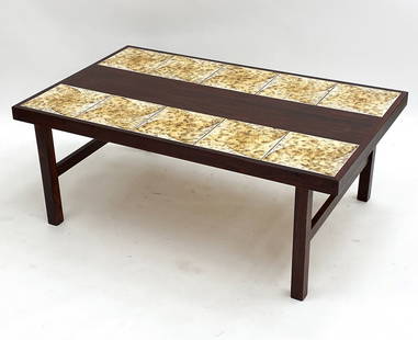 DANISH ROSEWOOD & CERAMIC TILE COFFEE TABLE 1970S: Rosewood veneer with ceramic tile top. Dimensions: H 20" x W 51.5" x D 31.25". Condition: Minor scuffs and rubs. Wear consistent with age and use.