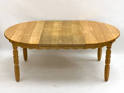 HENNING KJAERNULF OAK EXTENDING DINING TABLE: (2) Leaves included. Denmark, circa 1970s. Dimensions: H 19" x Dia. 48". Leaves W 26". Condition: Wear consistent with age and use.