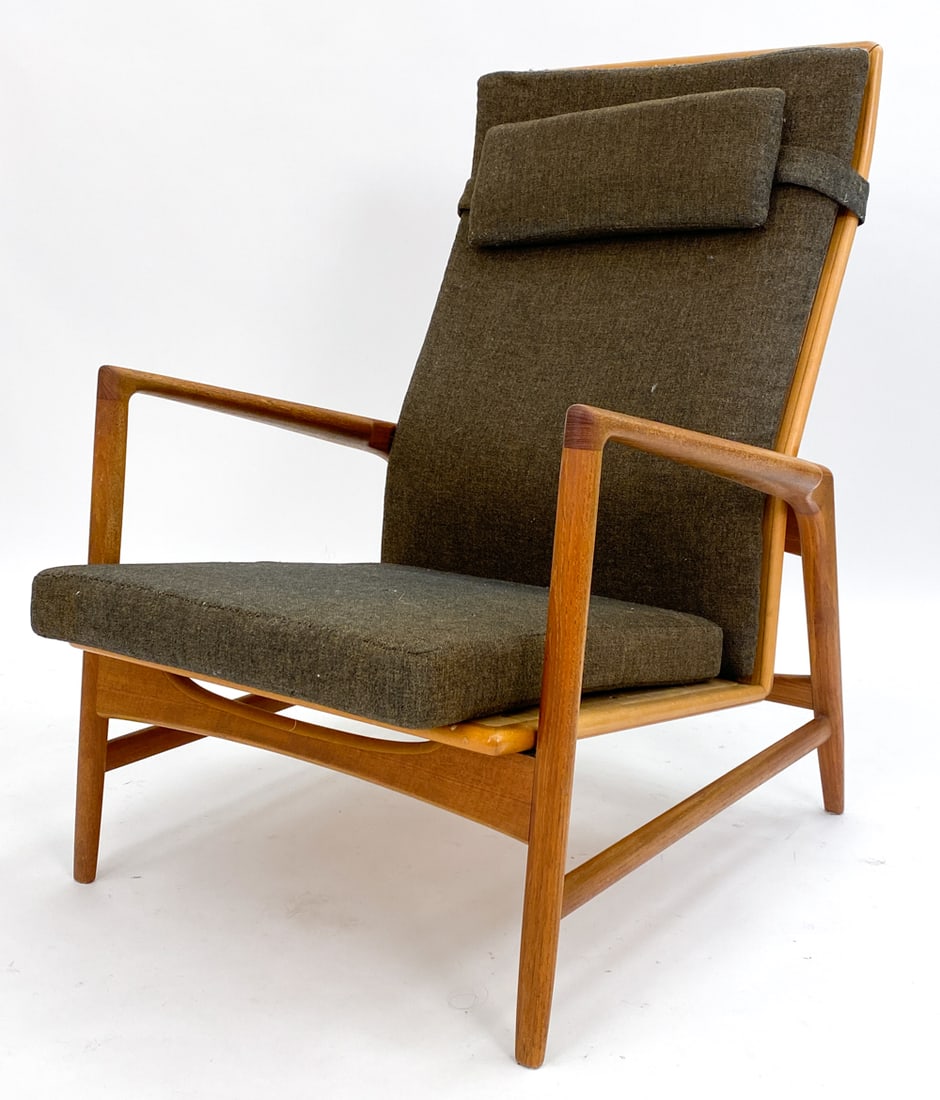IB KOFOD-LARSEN TEAK RECLINING LOUNGE CHAIR 1960S: Teak lounge chair with reclining feature. Wool cushion. Brass lever underneath adjusts reclining. Denmark, circa 1970s. Dimensions: H 38" x W 27" x D 32" x SH 15.5". Condition: Minor rubs and scuffs t