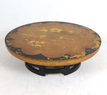 MUELLER & BARRINGER KITTINGER LOTUS COFFEE TABLE: Gilt and black lacquered table top painted with lotus design. Dimensions: H 14" x Dia 47.25" Condition: In need of refinishing, Moderate losses and scattered rubbing and nicks to finish.