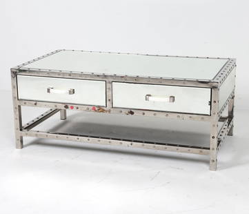 RIVETED STEEL & GLASS COFFEE TABLE: Beveled glass sides. Dimensions: H 17.5" x W 43.25" x D 23.75" Condition: Sticker and surface soiling to exterior. Scattered marks and scuffs to exterior. Wear consistent with age and use.