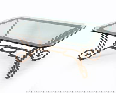 WROUGHT IRON & GLASS TOP COFFEE TABLE: Wrought iron frame. Glass top with beveled edges. Dimensions: H 20" x W 50.25" x D 32.25" Condition: Slight marks and scuffs to iron base. No issues noticed to glass. Presents well overall.