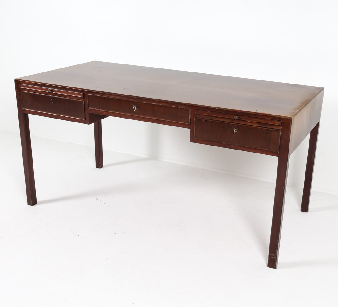 DANISH MAHOGANY WRITING DESK C. 1960S: Key included. Dimensions: H 29" x W 57.5" x D 28.75". Condition: Some faded spots, few surface scratches. Wear consistent with age and use.
