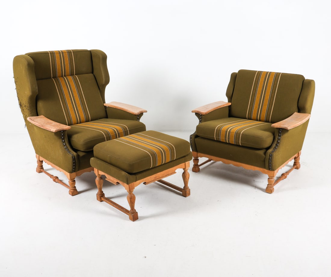 KJAERNULF STYLE DANISH OAK LOUNGE CHAIRS: Denmark, circa 1970s. His and hers with matching ottoman. Oak armrests. Carved legs and scalloped aprons. Green-tone wool upholstery and cushions with tack edges. Dimensions: (largest) H 39" x W 35" x