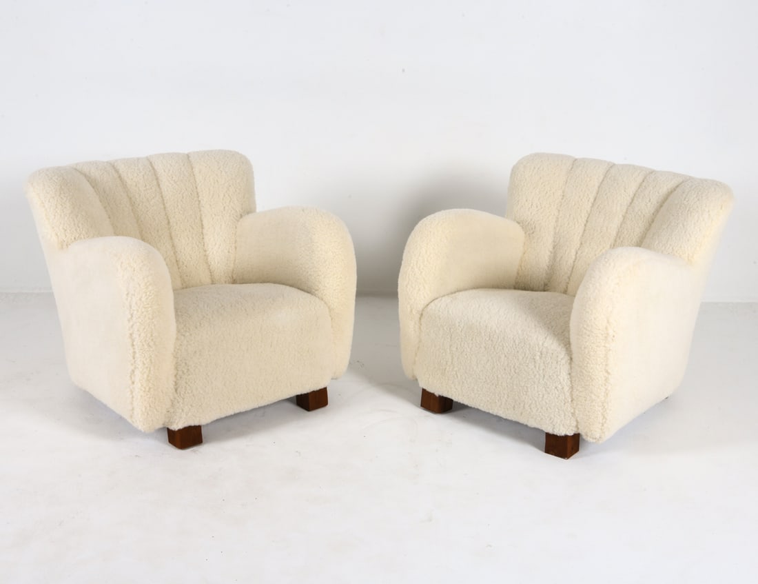 PAIR FLEMMING LASSEN STYLE LAMBSWOOL LOUNGE CHAIRS: White-tone lambswool upholstery. Dimensions: H 28.5" x W 21" x D 29", SH 16" Condition: Scuffs and nicks to wood legs. Presents well overall.