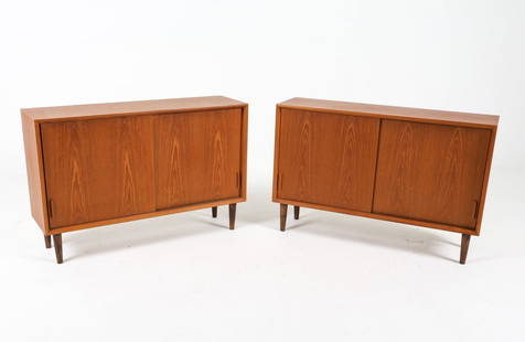 PAIR MID-CENTURY DANISH TEAK CREDENZAS C. 1960S: With adjustable shelves. Dimensions: H 26.25" x W 39.25" x D 11" Condition: Minor nicks to veneer. Rubbing to edges. Wear consistent with age and use, Presents well overall.