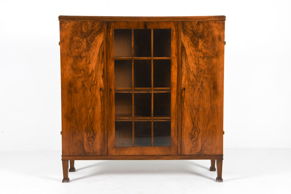 MID-CENTURY DANISH ROSEWOOD CABINET C. 1960S: Includes key. Adjustable shelves. Dimensions: H 57" x W 56" x D 17" Condition: Tarnishing to brass hinges. Slight rubbing and scuffs to exterior edges.