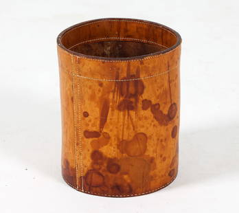 MID-CENTURY DANISH LEATHER WASTE BASKET C. 1960S: Dimensions: H 11.5" x Dia 10" Condition: Moderate blemishes throughout leather. Evident residue to interior. Tobacco odor. Wear consistent with age and use.