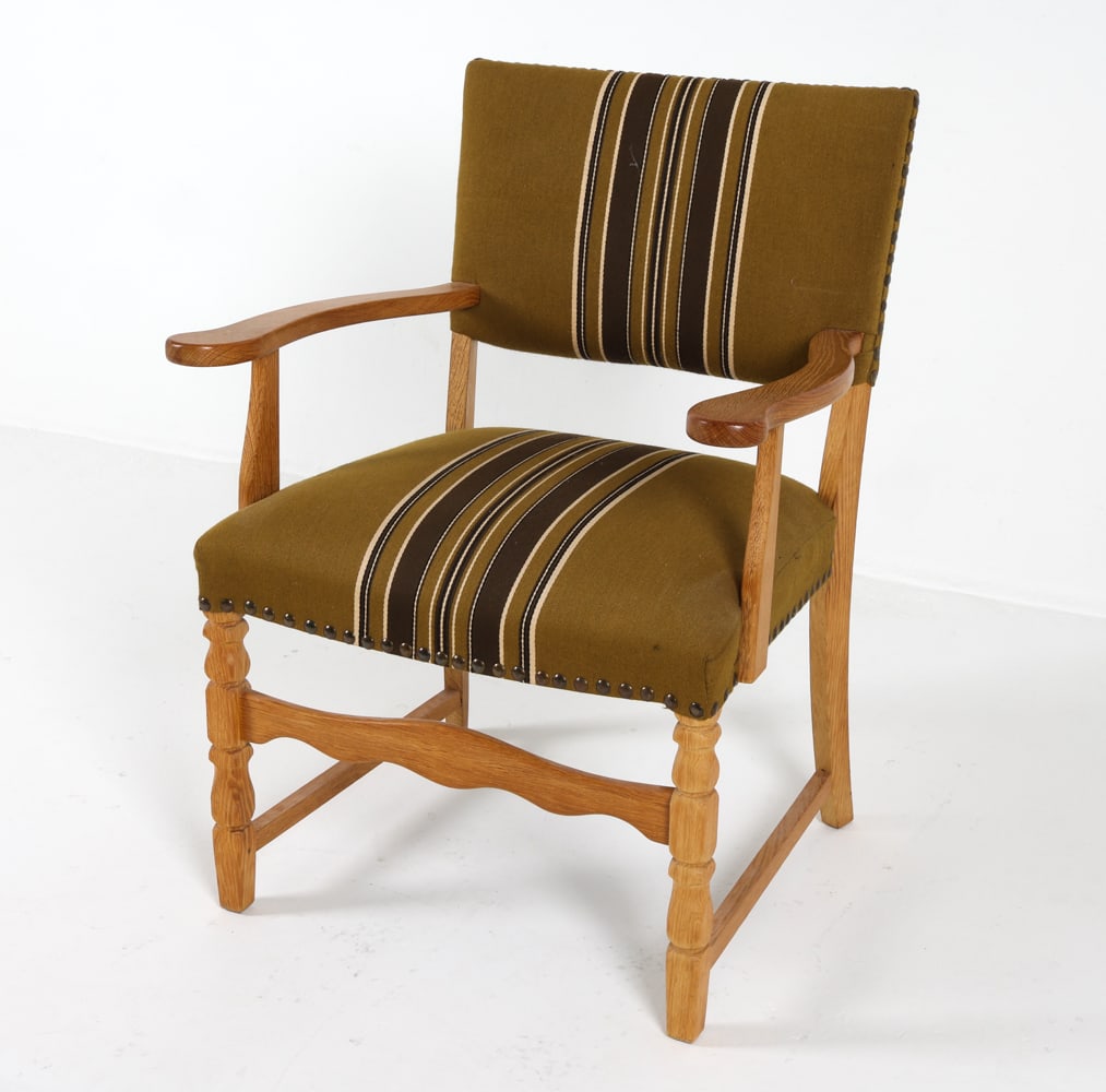 KJAERNULF STYLE DANISH OAK ARMCHAIR: Carved legs and sculpted armrests. Green-tone wool upholstery with tacked edges. Dimensions: H 34" x W 25" x D 21", SH 18.5" Condition: Minor blemishes to upholstery. Slight musty odor. Minor indentat