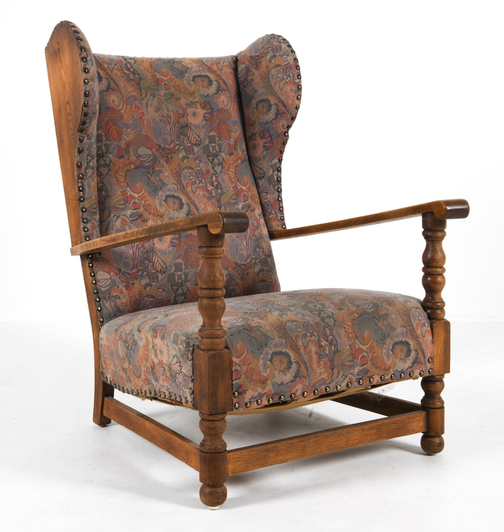 MID-CENTURY DANISH OAK WINGBACK LOUNGE CHAIR: Circa 1960s. Wingback with sculpted armrests and carved legs. Patterned wool upholstery with tacked edges. Dimensions: H 41.5" x W 29" x D 33", SH 15" Condition: Rubbing and scuffs to armrests. Slight