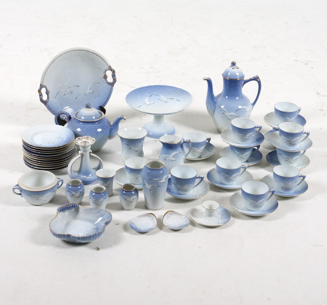 B&G ROYAL COPENHAGEN PORCELAIN GROUPING: Grouping with blue and white seagull pattern. Marked to undersides. (12) small plates, (12) saucers and (12) tea cups. Two-tiered tray. Tea pot and coffee pot. Cream and sugar. Other small dishes and