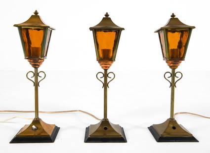 (3) SCANDINAVIAN BRASS TABLE LAMPS C. 1960S: (3) Brass and copper with amber glass panels. Dimensions: H 13.75" x W 4.5" x D 4.5" Condition: Tarnishing to copper and brass posts. Oxidation to iron bases. Scattered scuffs and scratches. Cut wires