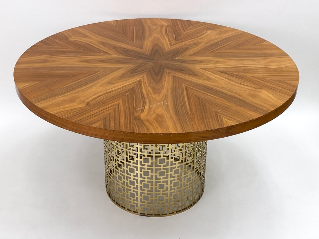 JONATHAN ADLER "NIXON" DINING TABLE: Table from the "Nixon" series by Jonathan Adler. Features a sunburst wooden top and a brushed openwork brass pedestal base. Dimensions: H 29.25" x Dia 53.5" Condition: Dings and nicks on side/edges of