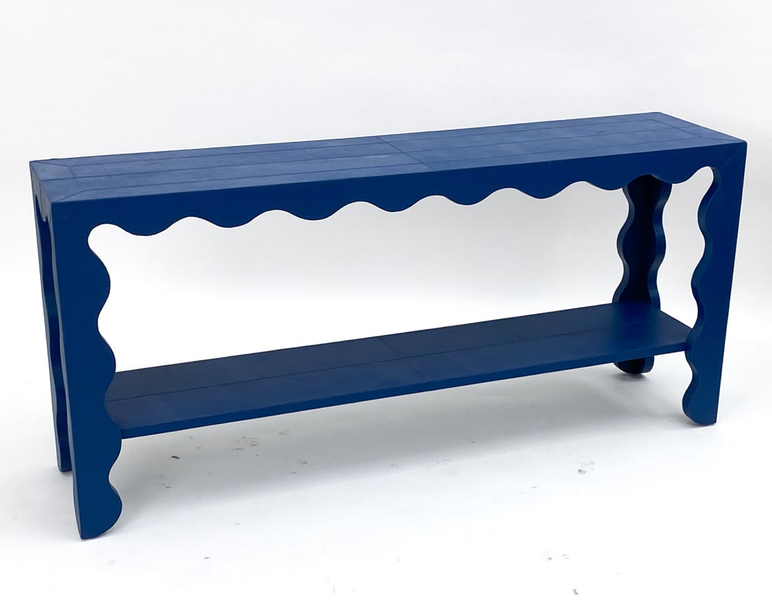 JONATHAN ADLER FLOW LEATHER WRAPPED CONSOLE: Features a scalloped edge console with stitched blue leather wrapped on all sides. Label on underside of top. Dimensions: H 30.25" x W 66.25" x D 15.25" Condition: Very light surface wear consistent w