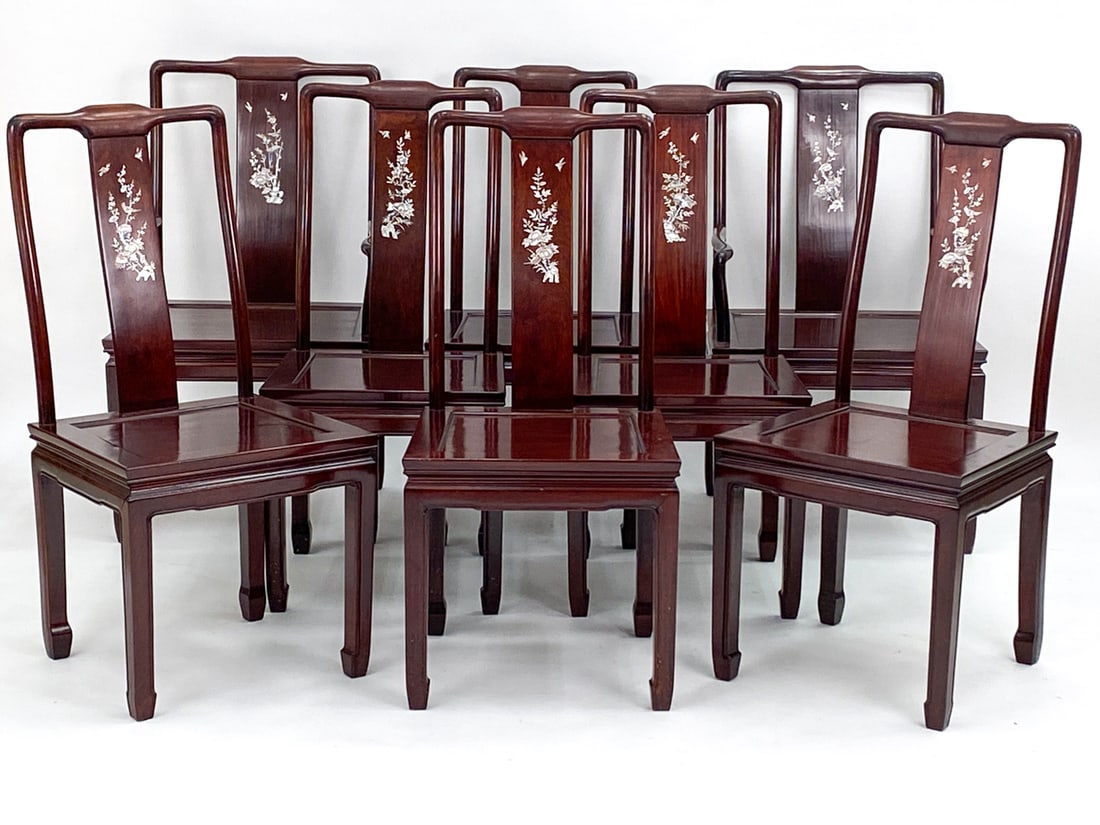 (8) CHINESE ROSEWOOD MOTHER OF PEARL DINING CHAIRS: Rosewood frames with mother of pearl inlay depicting flowers and birds. Includes (2) armchairs and (6) armless. Unmarked. Dimensions: (Armchairs) H 37.5" x W 22" x D 20" x SH 17" Condition: Some natur