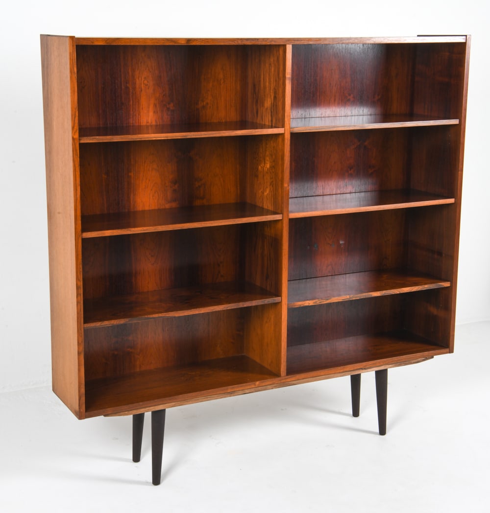 PMJ VIBY J DANISH ROSEWOOD BOOKCASE C. 1960S: Label to backside. Adjustable rosewood shelves. Dimensions: H 56.75" x W 56.5" x D 11" Condition: Blemishes to proper left back paneling. Peeling of backside veneer. Wear consistent with age and use.