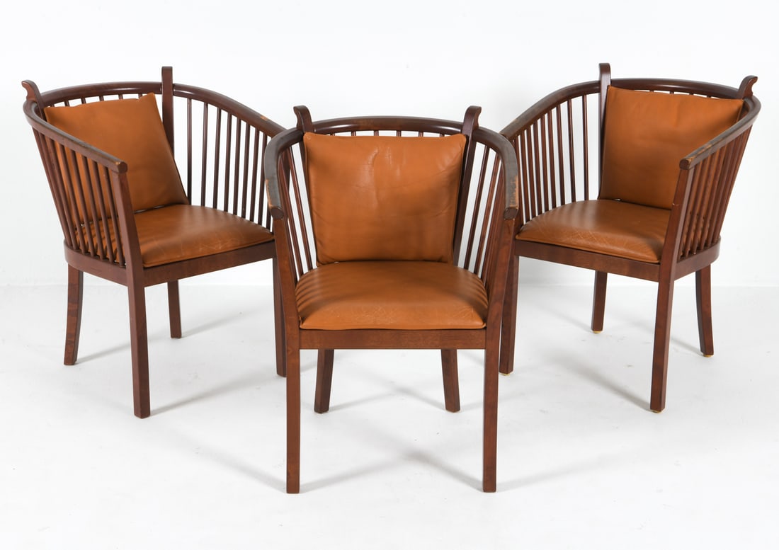 (3) MOBRING & JELINEK 'STOCKHOLM' LOUNGE CHAIRS: Barrel backs with cognac-tone leather upholstery and cushions. Dimensions: H 30" x W 23" x D 19", SH 17" Condition: Moderate rubbing and scuffs to finish. Light creases to leather cushions. Wear consi