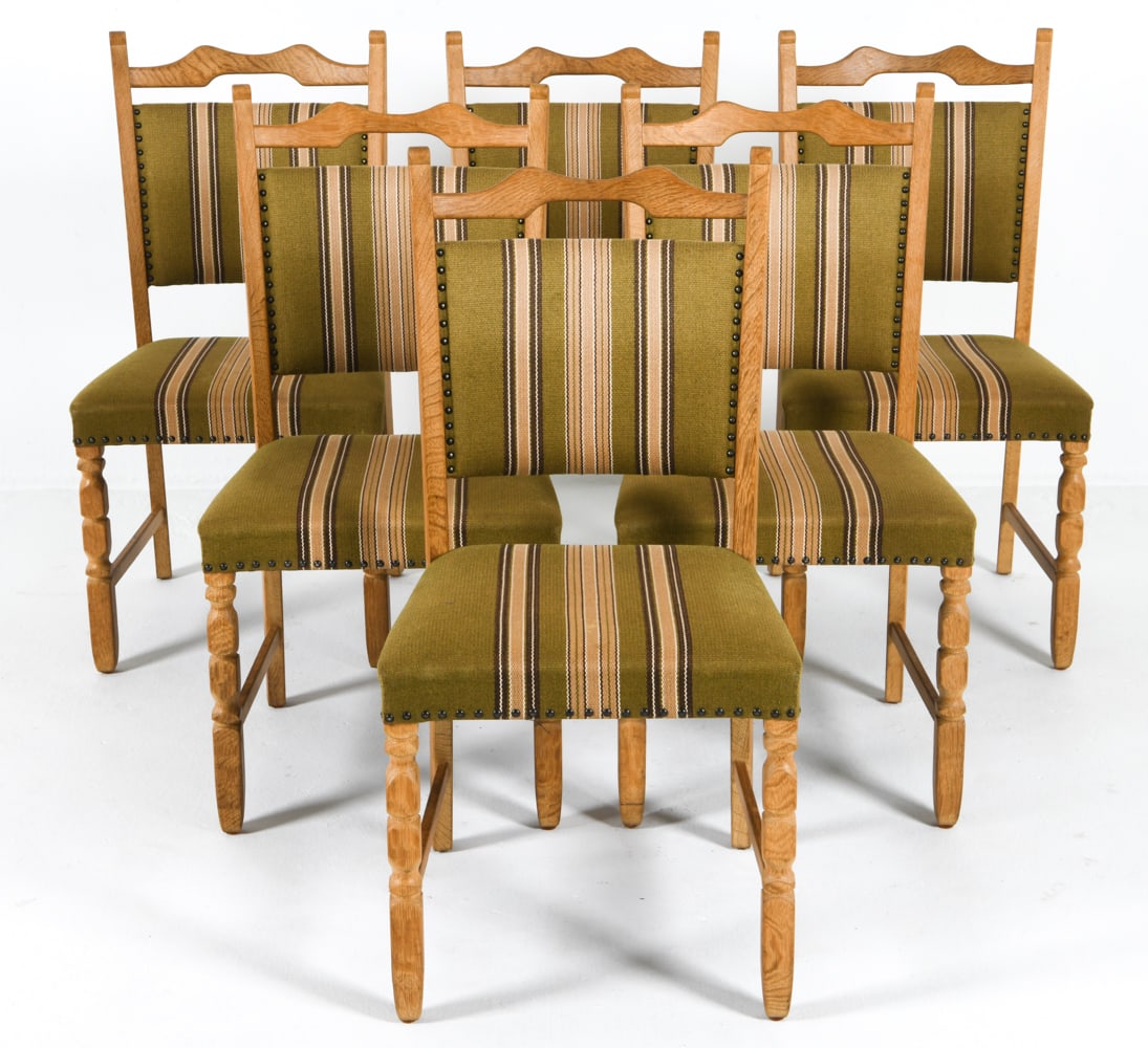 6 HENNING KJAERNULF STYLE DANISH OAK DINING CHAIRS: Carved legs, green-tone wool upholstery with tack edges. Dimensions: H 37" x W 19" x D 17", SH 18" Condition: Light rubbing and scuffs to frame. Presents well overall. DDE C