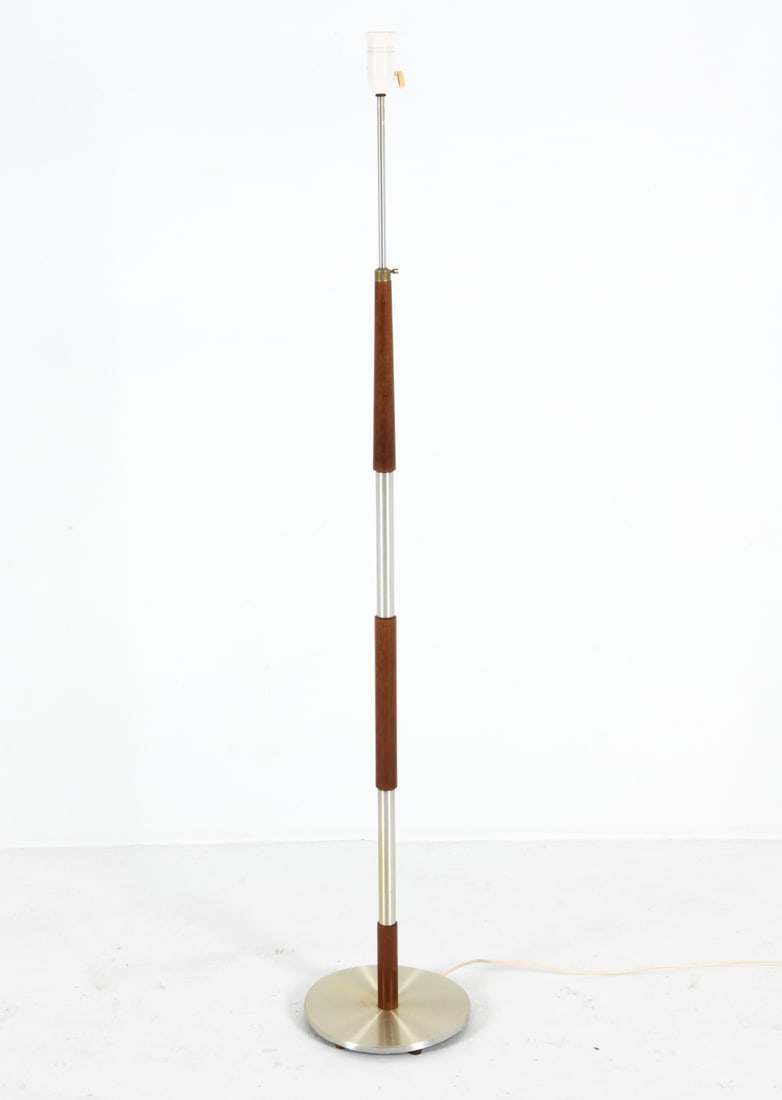 DANISH MID-CENTURY TEAK & METAL FLOOR C. 1960S: With adjustable height. Dimensions: H 56" x Dia 10.25" Condition: Scattered nicks and dings to base. Light scuffs to teak sections. With European plug. Untested. Wear consistent with age and use.