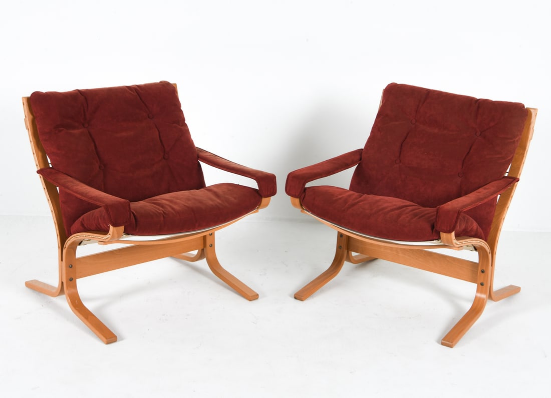 INGMAR RELLING SIESTA OAK & SUEDE LOUNGE CHAIRS: Red-tone suede upholstery with oak frames. Dimensions: H 31" x W 28.5" x D 27", SH 18" Condition: One chair with more discolored upholstery than the other. Minor scuffs to frames. Musty odor to uphols