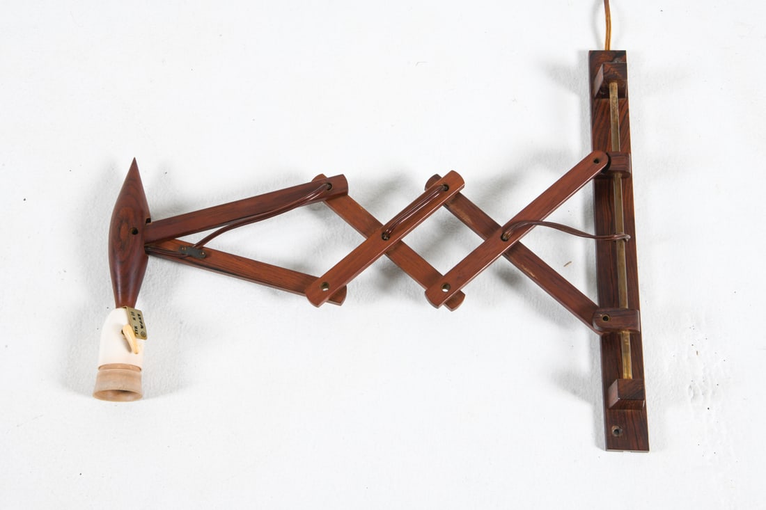 LYFA DANISH ROSEWOOD SCISSOR WALL SCONCE C. 1970S: Label to socket. Dimensions: H 15.25" x W 1.5" x D 12" Condition: Light scuffs and nicks. European plug. Untested. Wear consistent with age and use. DDE C