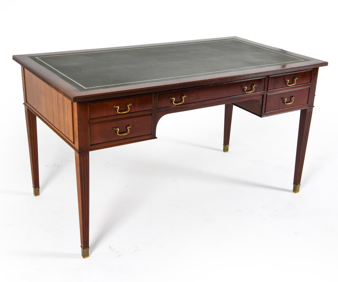 FRITS HENNINGSEN STYLE DANISH MAHOGANY DESK: Circa 1960s. Brass hardware with fluted legs and brass capped feet. Dimensions: H 29.25" x W 53.75" x D 29.5" Condition: Rubbing and marks to finish. Tarnishing to brass. Slight musty odor to drawer i
