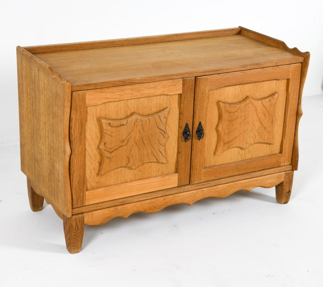 HENNING KJAERNULF DANISH OAK CREDENZA C. 1970S: Label to backside. Carved brutalist cabinet doors. Iron hardware. Dimensions: H 25.25" x W 39" x W 18" Condition: Water marks and surface scratches. Slight musty odor to interior. Wear consistent with