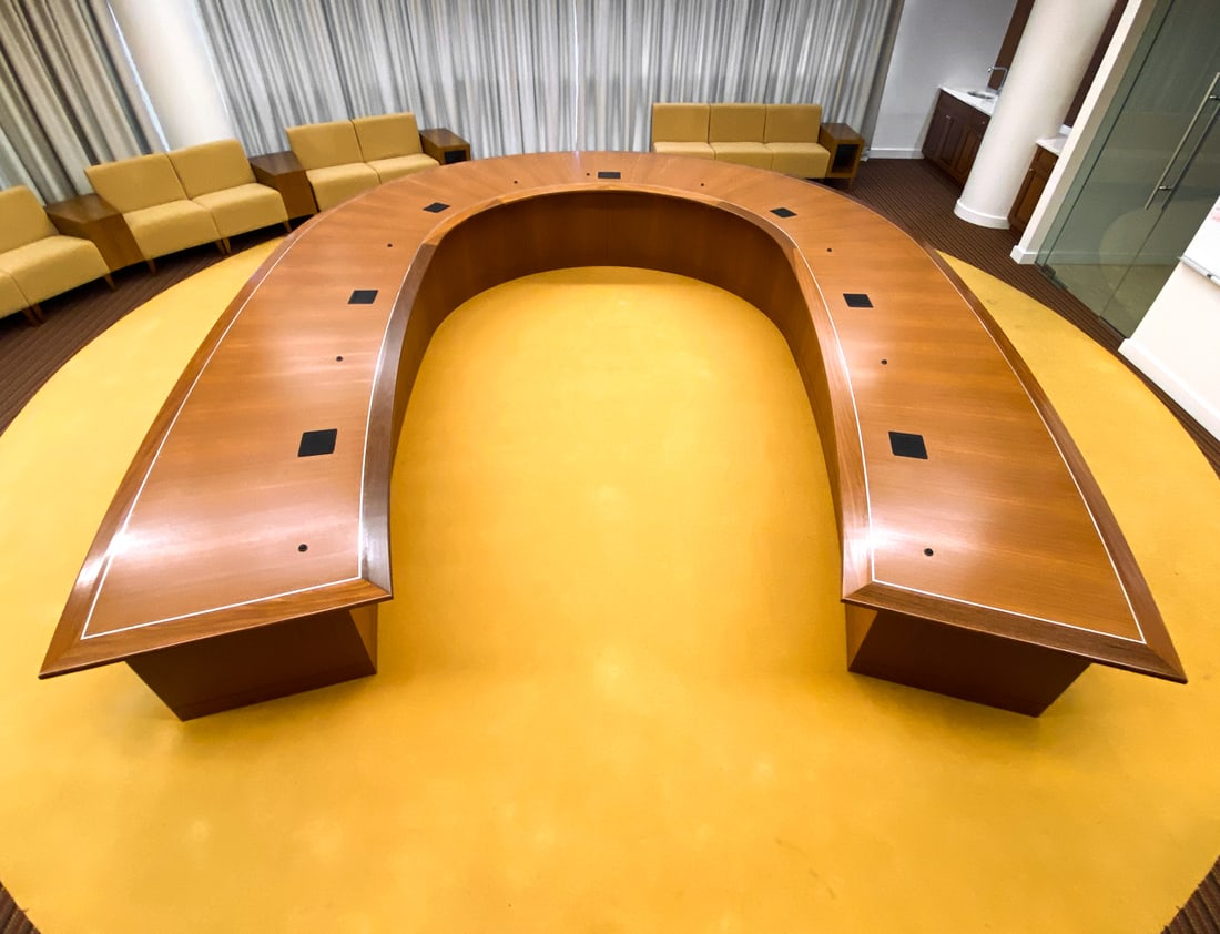MONUMENTAL HORSESHOE CONFERENCE TABLE: Completely wired with Crestron system. Includes 9 microphones and 7 Crestron power outlets built-in. Must be dismantled for removal, buyers responsibility. Dimensions: (Altogether, assembled) H 30" x