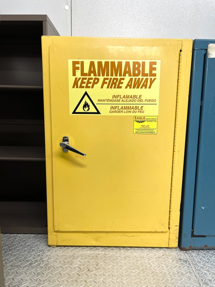 EAGLE MANUFACTURING FLAMMABLE SAFTEY CABINET: Model 1925, 12 gallon capacity, meets OSHA requirements. Dimensions: H 35.5" x W 23.25" x D 18.5" Condition: Lacking key and shelves. Soiling and wear consistent with use.