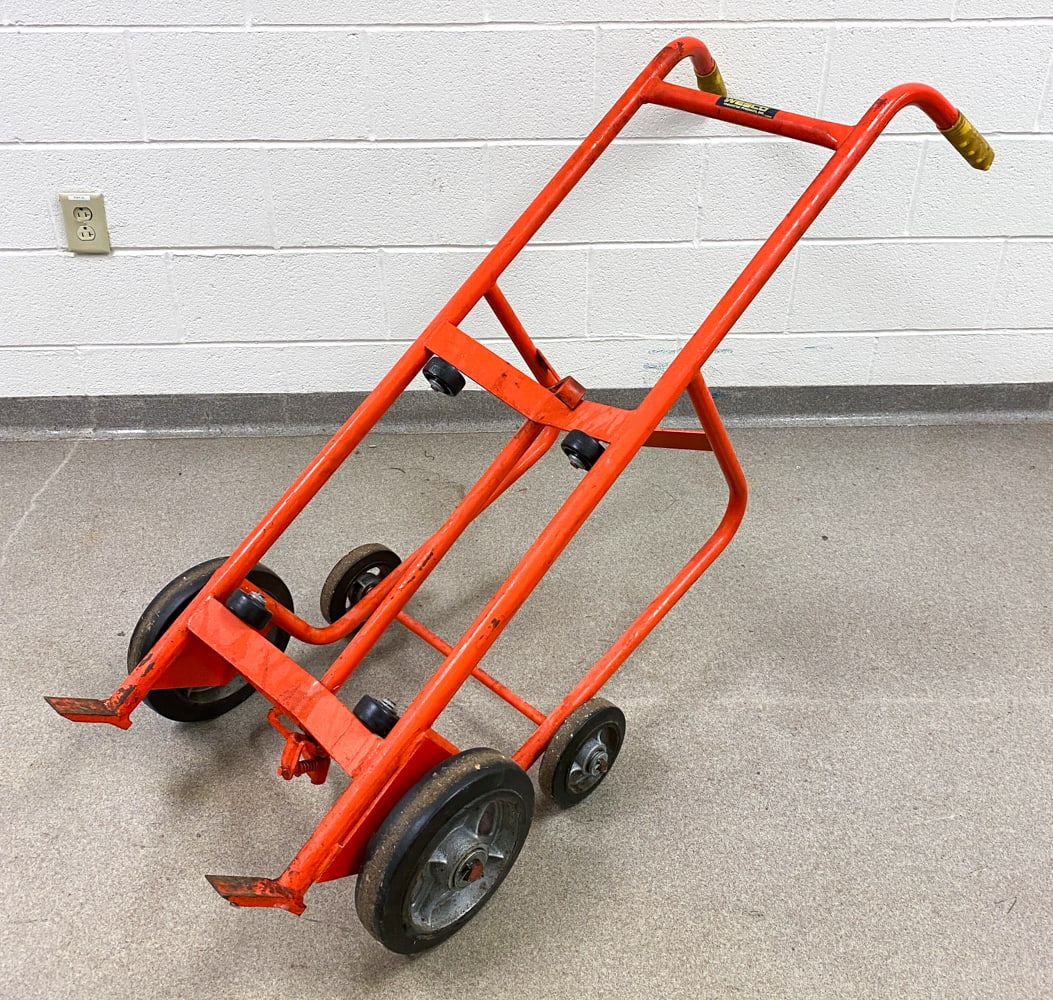 INDUSTRIAL DRUM TRUCK BARREL DOLLY: Designed to move and dispense 30-55 gallon barrels or drums with easy. Features 4 wheels. Can carry up to 1000 pounds. Dimensions: H 54" x W 16" x D 19" Condition: Soiling, scratches, paint loss, and