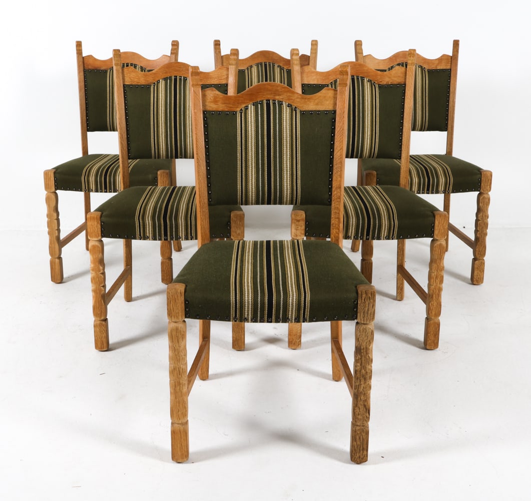 (6) HENNING KJAERNULF STYLE DANISH DINING CHAIRS: Oak dining chairs in the style of Henning Kjaernulf. Upholstery made of wool with brass tack accents. Denmark, circa 1970s. Dimensions: H 36.25" x W 19" x D 17.5" x SH 17.5". Condition: Minor scuffs a