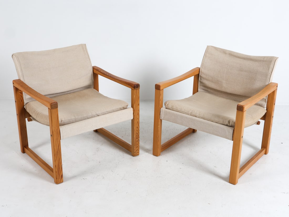 PAIR OF KARIN MOBRING IKEA PINE LOUNGE CHAIRS: Pair of lounge chairs designed by Karin Mobring for Ikea. Pine frames with sling canvas seats. Sweden, circa 1970s. Dimensions: H 27.25" x W 25" x D 25" x Sh 14.5". Conditions: Light surface wear cons