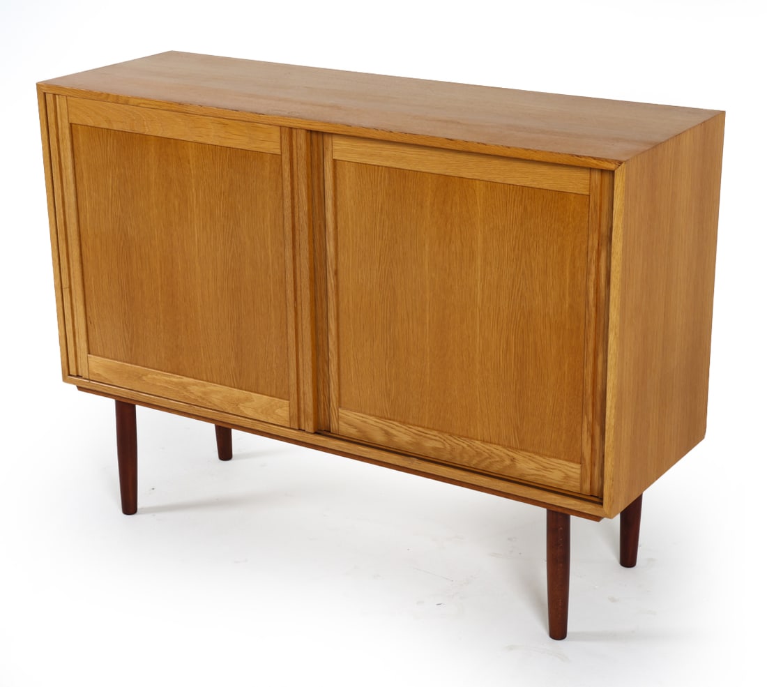 DANISH OAK SIDEBOARD CREDENZA C. 1960S: Adjustable shelves. Dimensions: H 34.5" x W 47.5" x D 15.75". Condition: Minor scuffs and rubs, some sun fading to top. Wear consistent with age and use. GCE032
