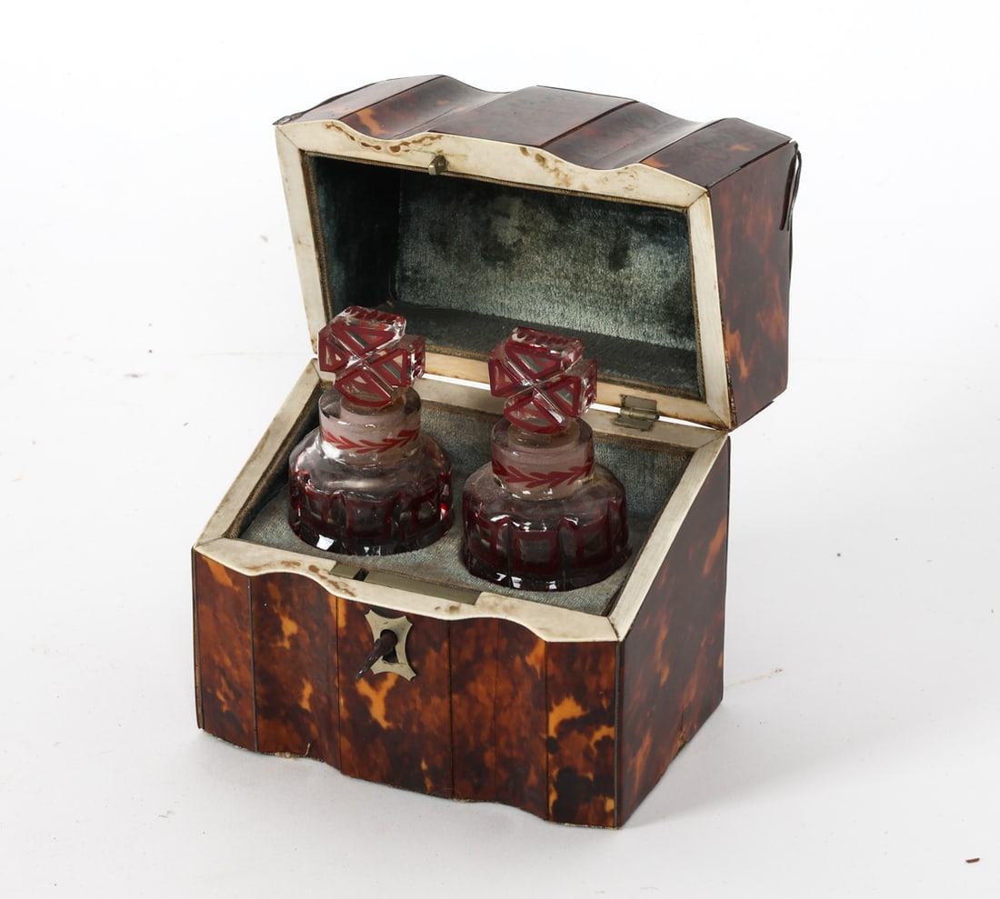 ANTIQUE VICTORIAN DOUBLE PERFUME CASKET: Box with shaped front and metal inlaid accents. Inside contained (2) glass perfume bottles with red decoration. Bone inlaid accent to interior edges. Circa 19th century. Dimensions: Box H 5" x W 4.25"