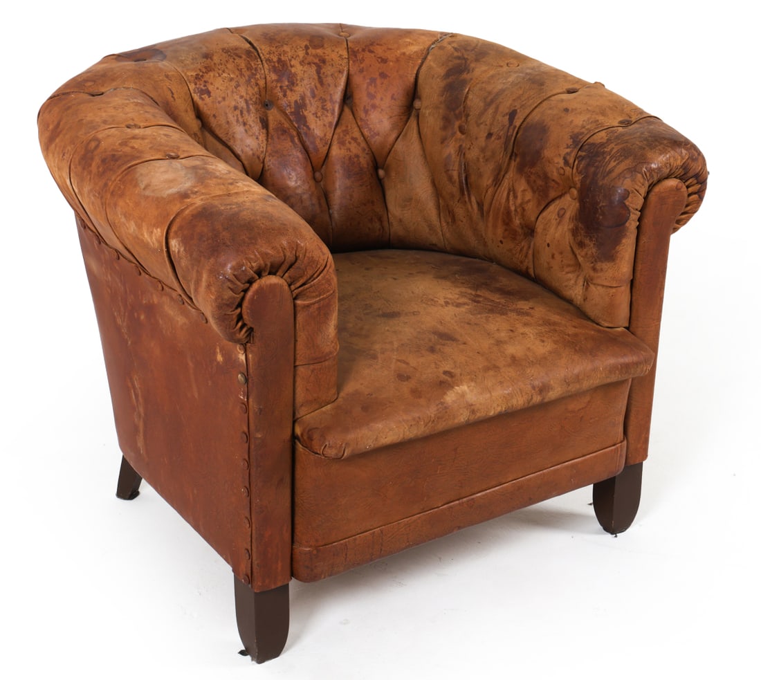 MID-CENTURY SCANDINAVIAN LEATHER CLUB CHAIR: Brown leather club chair with tufted back and roll arms. Circa 1940s. Dimensions: H 27" x W 33.5" x D 32" x SH 15.75". Condition: Areas of discoloration to leather. Few tears. Scuffs and scratches to