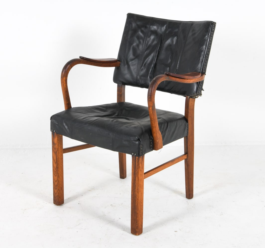MID-CENTURY DANISH TEAK & LEATHER ARMCHAIR C. 1960: Black-tone leather upholstery with tack edges. Dimensions: H 34.5" x W 24" x D 18.5", SH 18" Condition: Moderate indentation to minor burn hole to seat leather. Back rest leather has moderate tears an