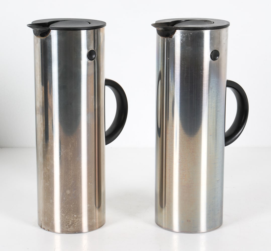 PAIR OF DANISH STELTON STEEL THERMOS: Pair of Stelton thermoses designed by Erik Magusses. Stainless steel exteriors with plastic. One with original box. Dimensions: H 12" x W 6.5" x Dia. 4.25". Condition: Minor scuffs to thermoses. Scrat