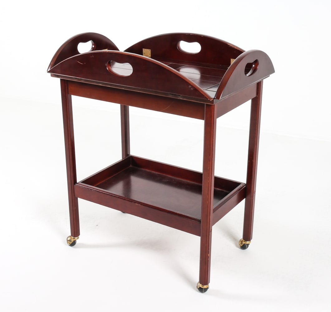 SCANDINAVIAN MAHOGANY BUTLER'S TRAY TABLE 20TH C.: Mahogany with brass hinges. Dimensions: H 29.5" x W 35.5" x D 25.25". Condition: Few scuffs and dings. Wear consistent with age and use.