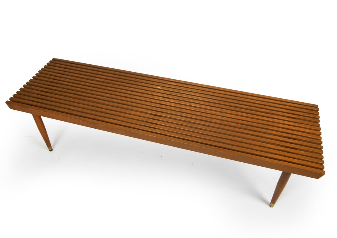MID-CENTURY PINE SLAT BENCH: Unmarked. Bench or coffee table. Pine with a dark stain finish. Dimensions: H 15" x W 59.75" x D 17.25" Condition: Wear consistent with age and use. Some rubs and loss of finish.