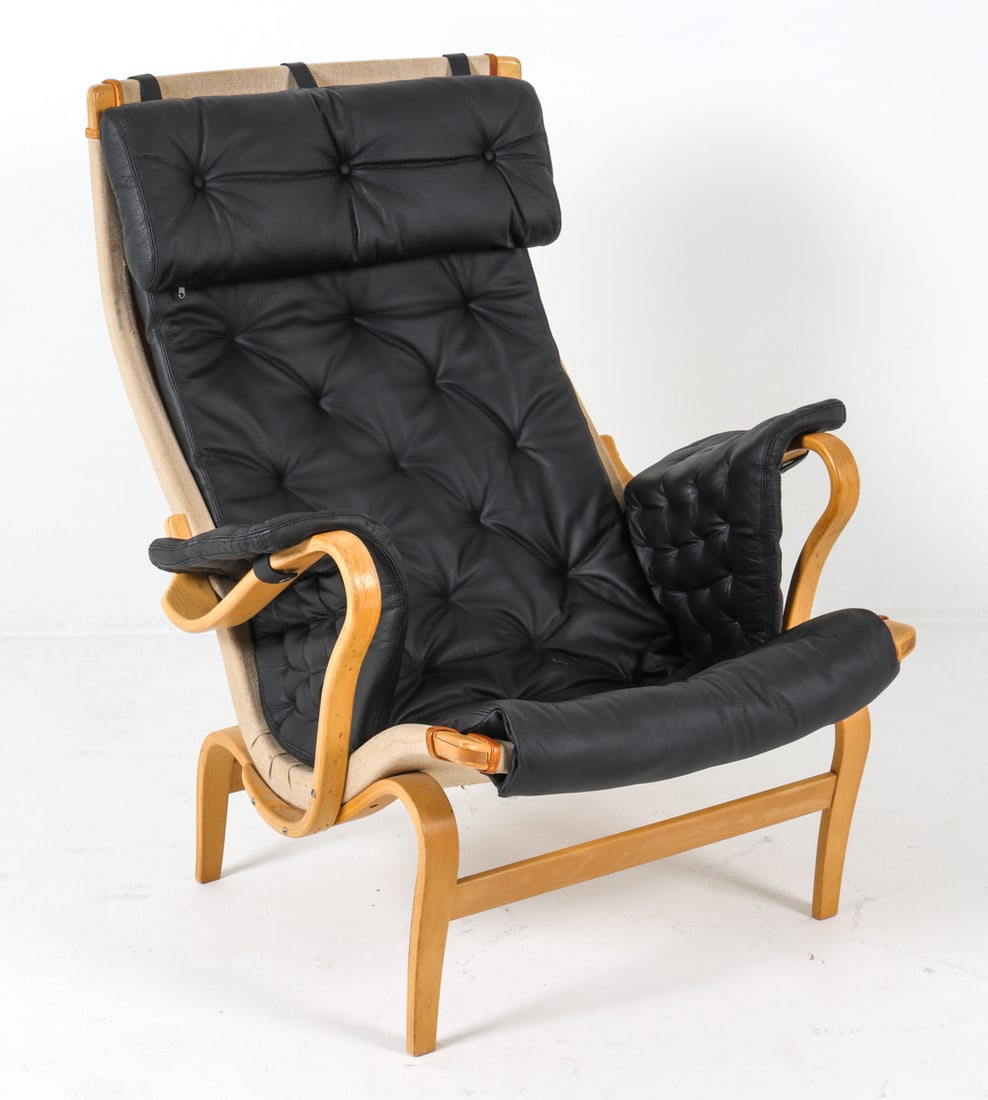 BRUNO MATHSSON DUX 'PERNILLA' LOUNGE CHAIR: Beech bentwood frame with black leather cushion, canvas seat backing. Marked to stretcher bar. Sweden, circa 1970s. Dimensions: H 50" x W 32.5" x D 30" x SH 17.75". Condition: Some slight discoloratio