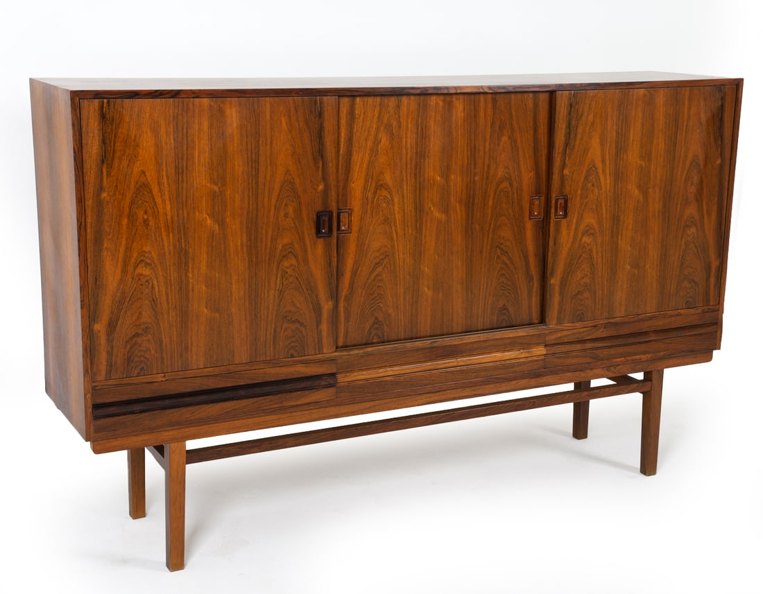 OMANN JUN STYLE ROSEWOOD HIGHBOARD C. 1960S: Adjustable shelves. Marked 'Danish Control' inside. Denmark, circa 1960s. Dimensions: H 48.75" x W 78" x D 17". Condition: Few faint water rings to interior. Wear consistent with age and use. JE036