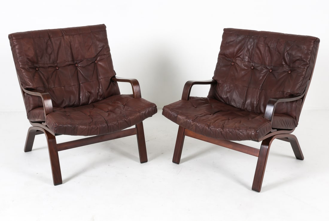 PAIR OF MILJO RANGE STYLE LEATHER LOUNGE CHAIRS: Pair of lounge chairs in the style of Miljo Range for Farstrup Mobler. Beech ladder back frames with brown leather upholstery. Circa 1960s. Dimensions: H 32.5" x W 26.5" x D 29.5" x SH 17". Condition: