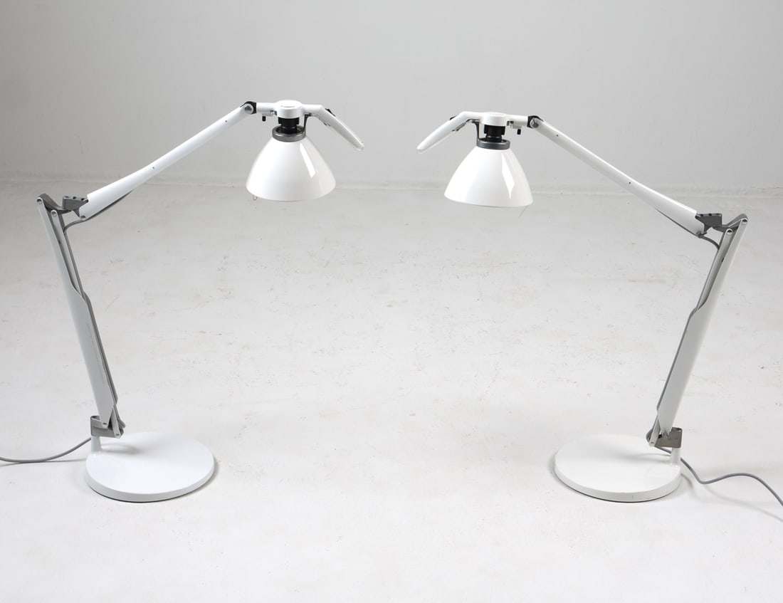 PAIR OF LUCEPLAN FORTEBRACCIO TABLE LAMPS: Designed by Alberto Meda and Paolo Rizzatto. Marked to stands. Cast iron weighted bases. Italy, late 20th century. Dimensions: H 22" x W 25" x Dia. Base 10". Condition: Wiring untested, European plugs