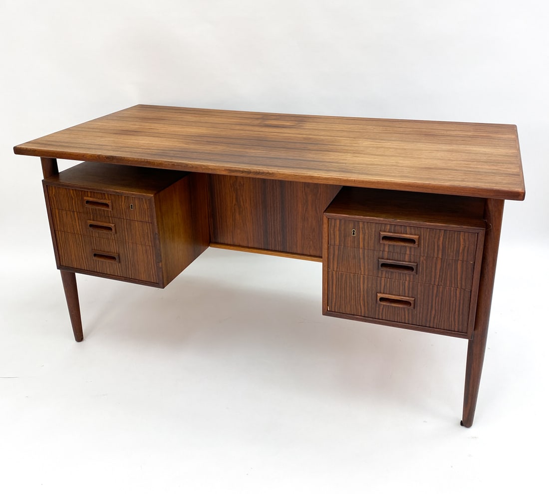 ARNE VODDER FOR SIBAST ROSEWOOD DESK C. 1960S: Rosewood executive desk by Arne Vodder for Sibast. Retains two keys. Apparently unmarked. Denmark, circa. 1960s. Dimensions: H 29.5" x W 58" x D 28" Condition: Wear consistent with age and use, includ