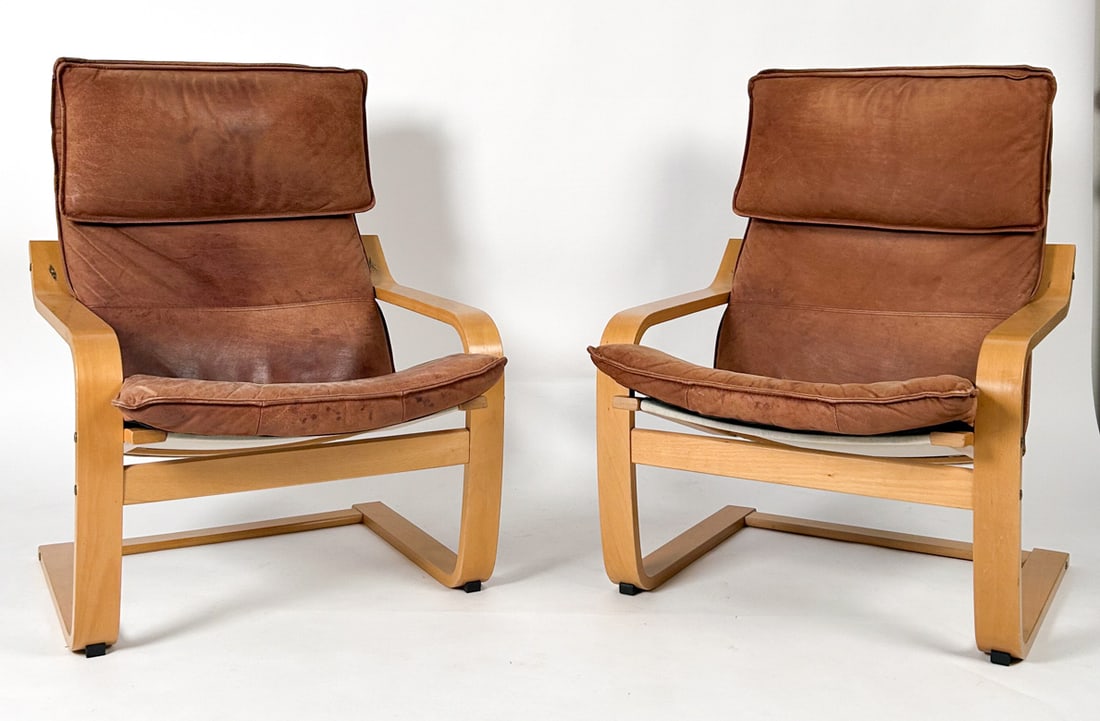 PAIR OF IKEA "POANG" LEATHER LOUNGE CHAIRS C.1970S: Designed by Noboru Nakamura for Ikea. Featuring tan leather upholstery above a canvas backing and beech bentwood frames. Labeled on undersides. Sweden, circa 1970s. Dimensions: H 36" x W 26.75" x D 30