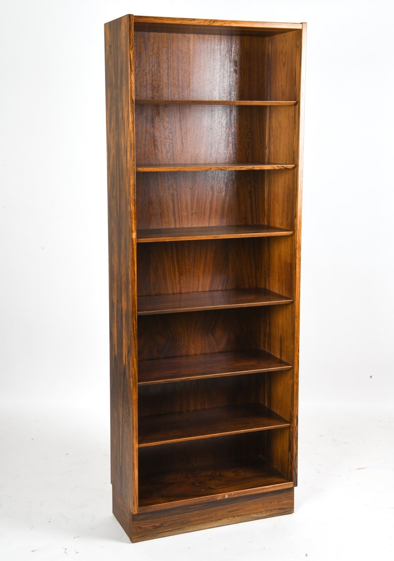 ATTR. HUNDEVAD & CO ROSEWOOD BOOKCASE C. 1970S: Tall bookcase in rosewood veneer attributed to Hundevad & Co. Denmark, circa 1970s. Dimensions: H 77.5" x W 27.75" x D 12" Condition: Wear consistent with age and use. Minor surface and scratches. Sli