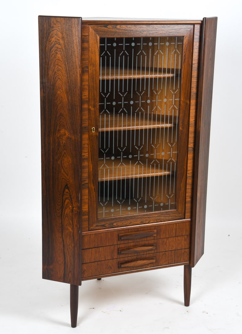 ATTR. OMANN JUN DANISH ROSEWOOD CORNER CABINET: Corner cabinet with etched glass door, interior shelves, and three small shelves below attributed to Omann Jun. Includes key. Apparently unmarked. Denmark, circa 1960s. Dimensions: H 57.5" x W 35" x D