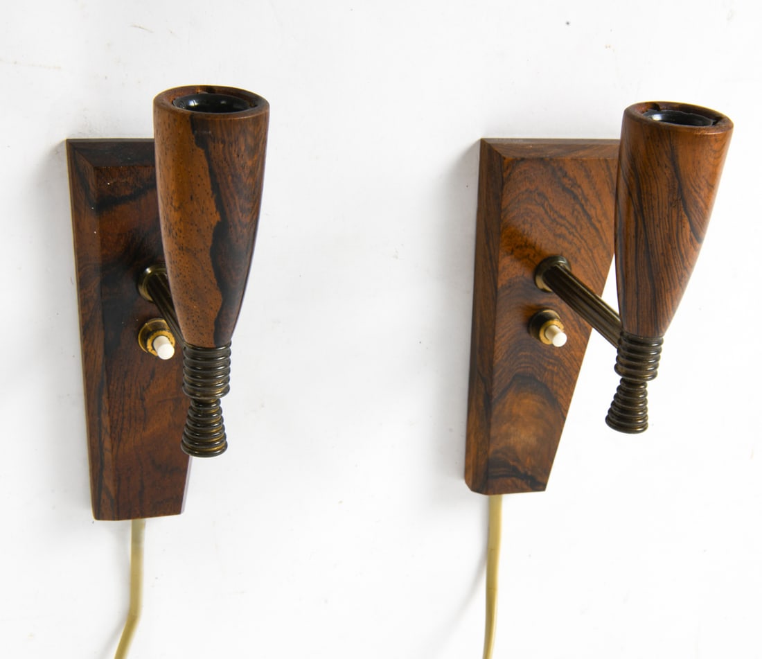 LAONI BELYSNING DANISH ROSEWOOD WALL SCONCES 1960S: Brass and rosewood. Includes (2) shades that sit on bulbs. Remnants of labels on mount. Denmark, circa 1960s. Dimensions: H 7" x W 2.25" x D 4" Condition: Light surface marks consistent with age and u